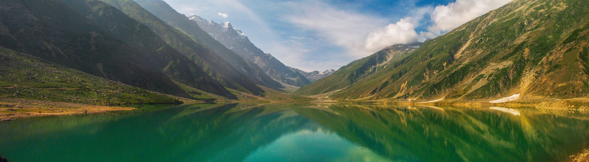 green lake surrounded by mountain